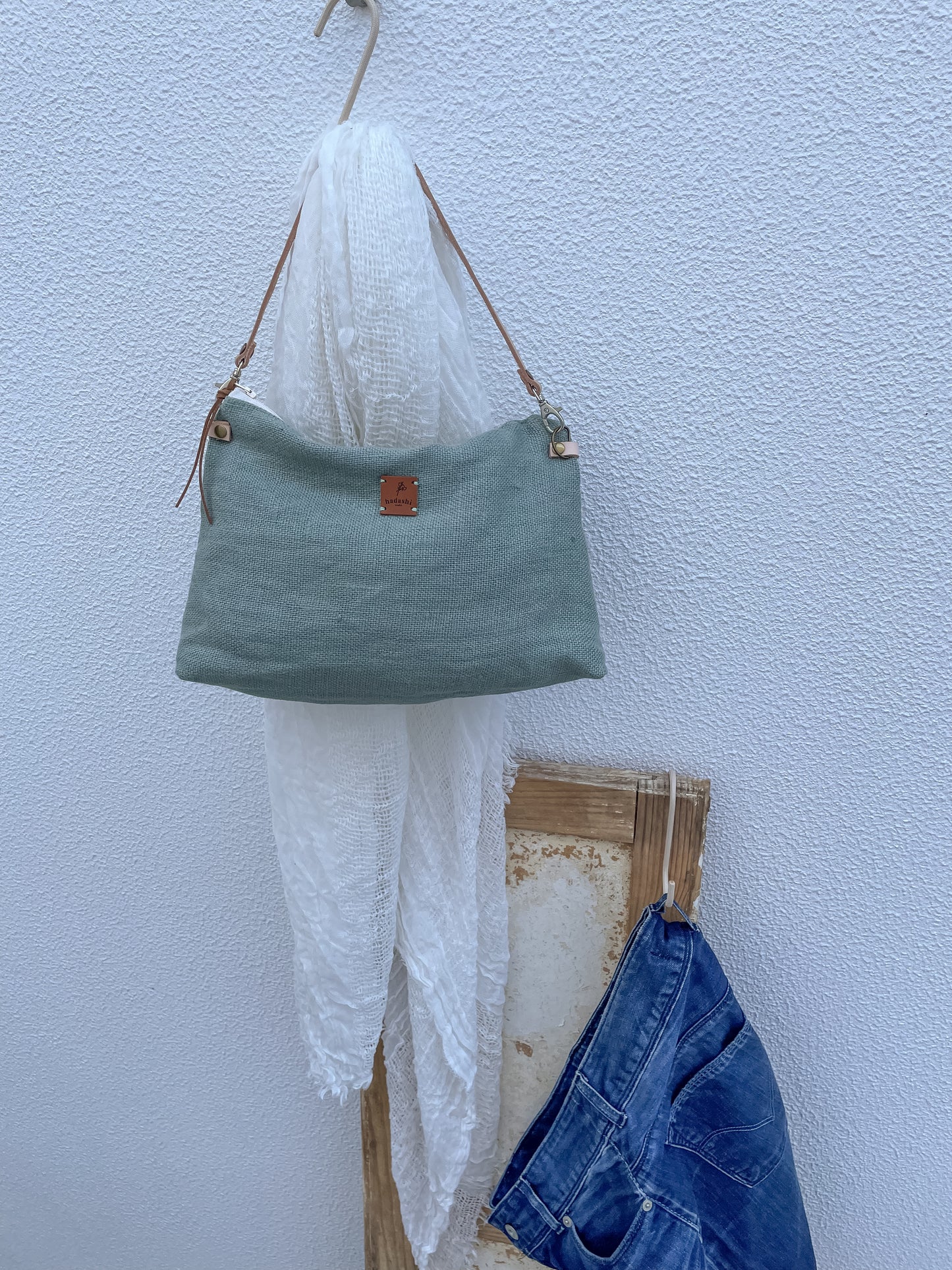 linen slouchy pouch in green with thin leather strap