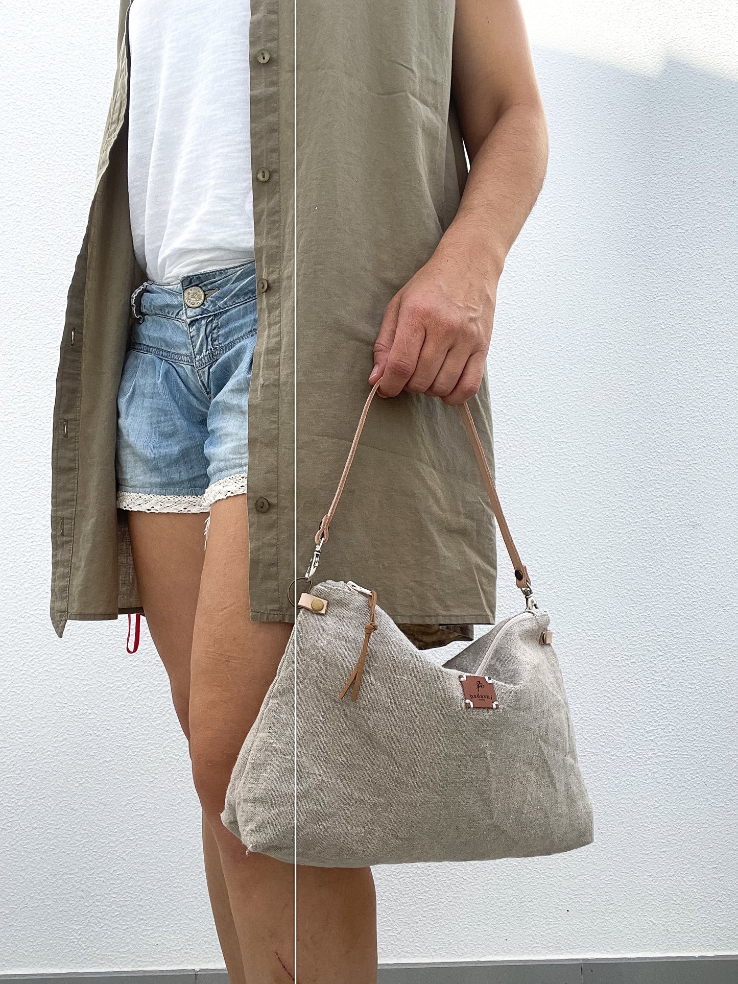 woman wearing a denin shorts and a linen slouchy pouch in beige with thin leather strap