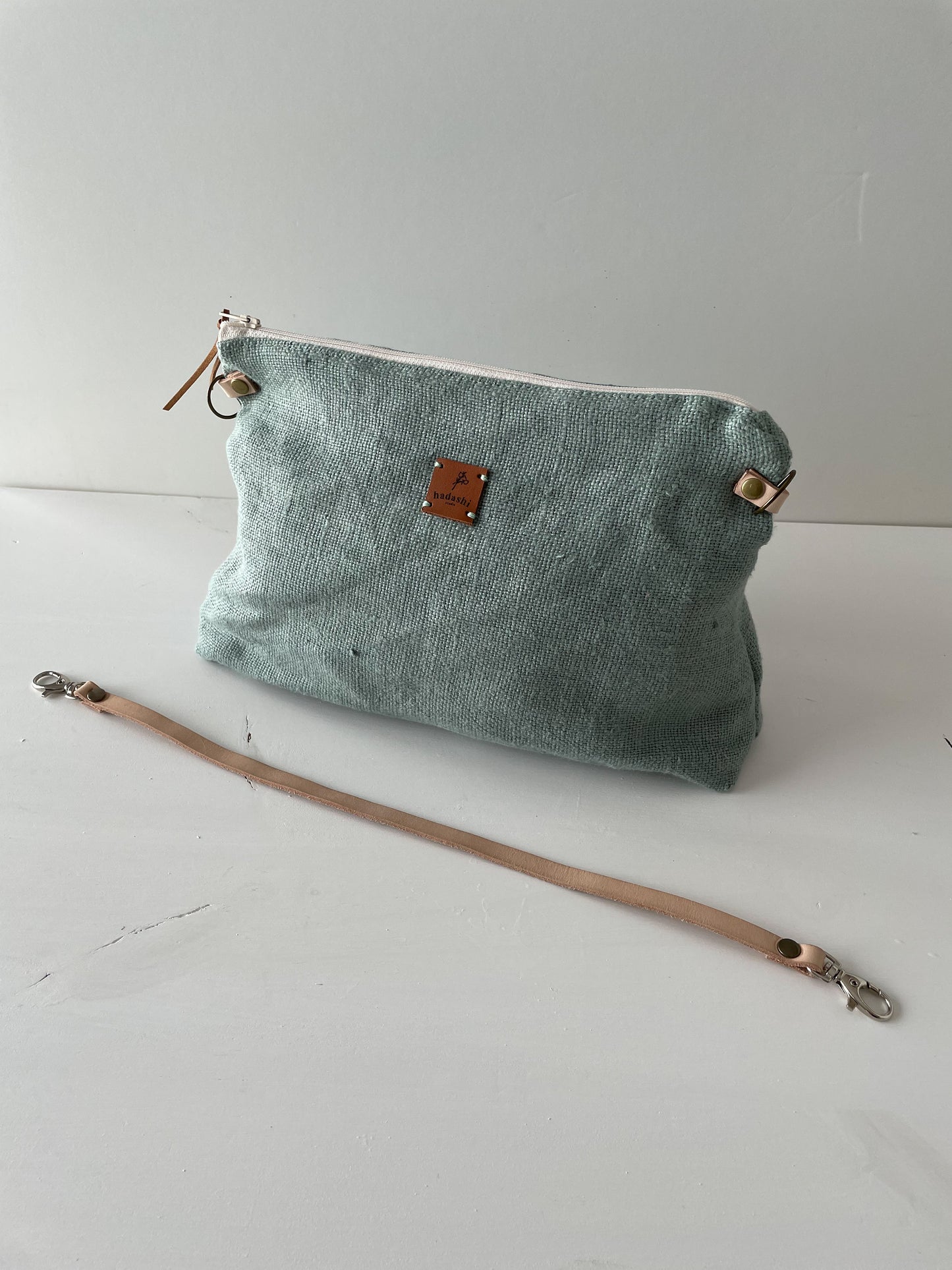 linen slouchy pouch in green with thin leather strap