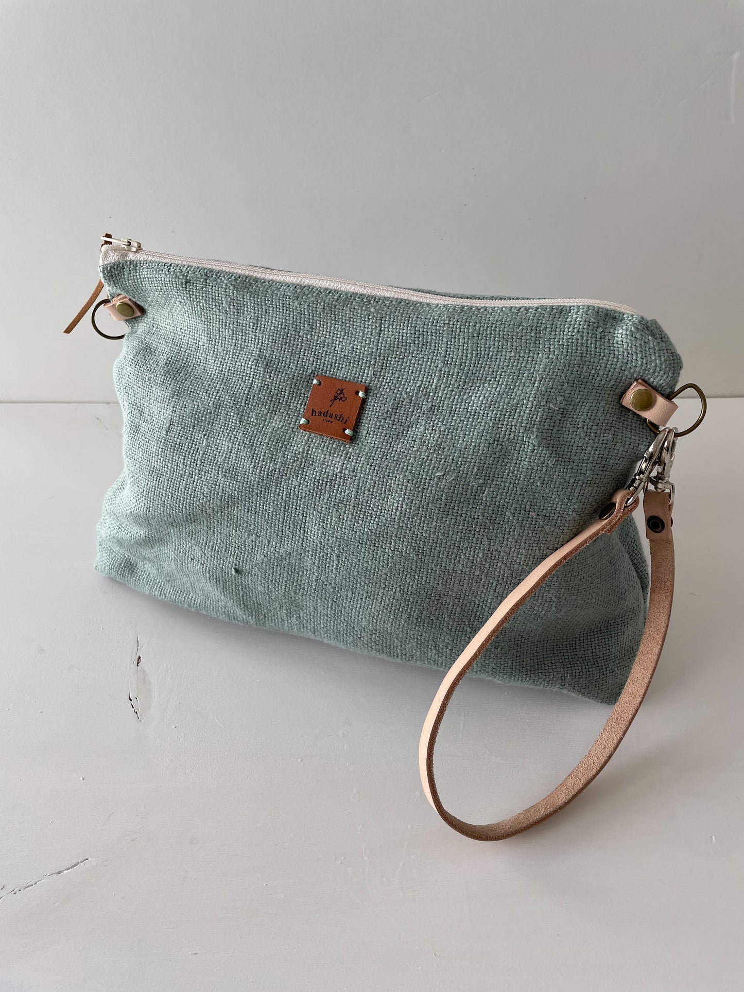 linen slouchy pouch in green with thin leather strap