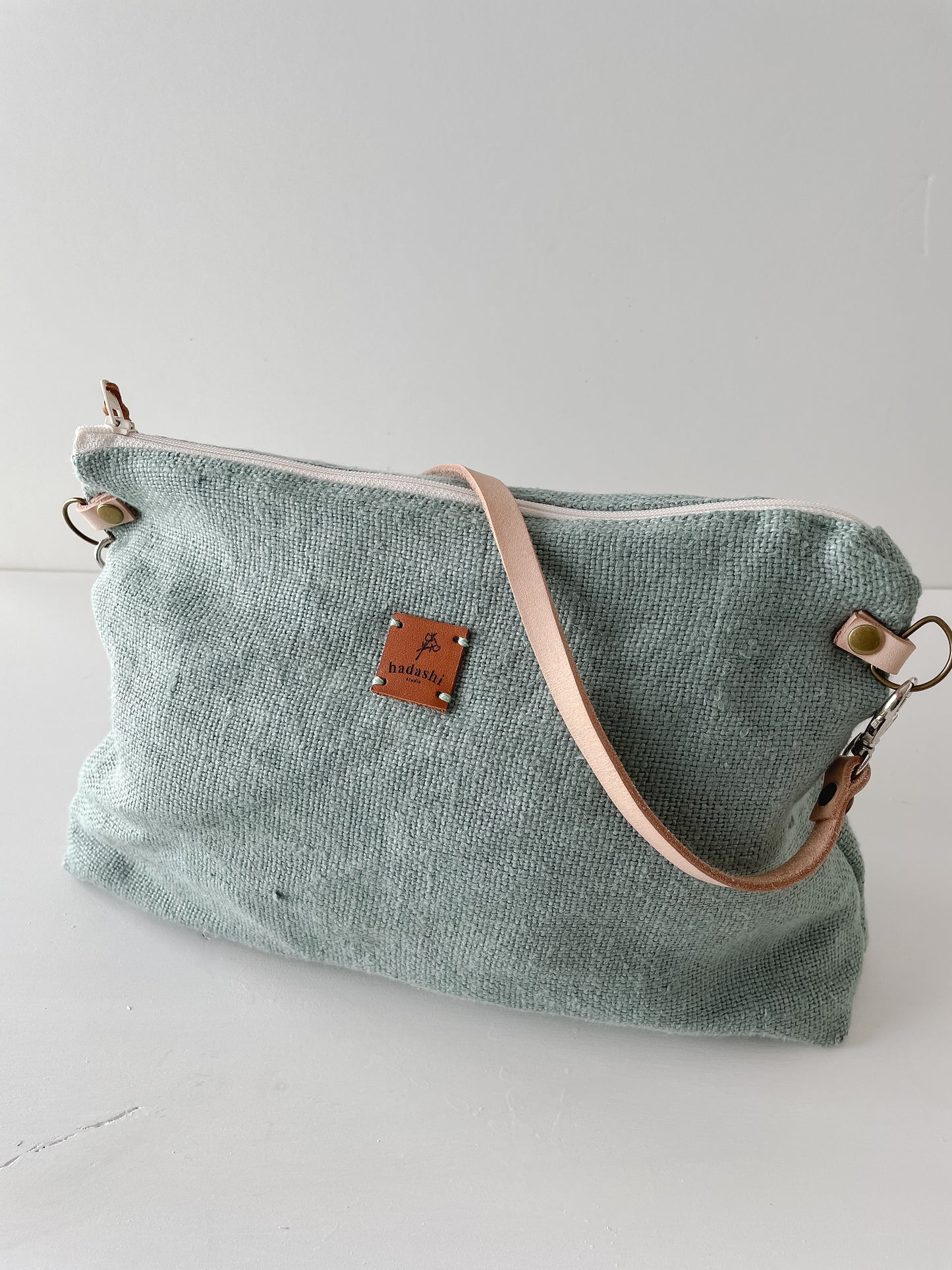 linen slouchy pouch in green with thin leather strap