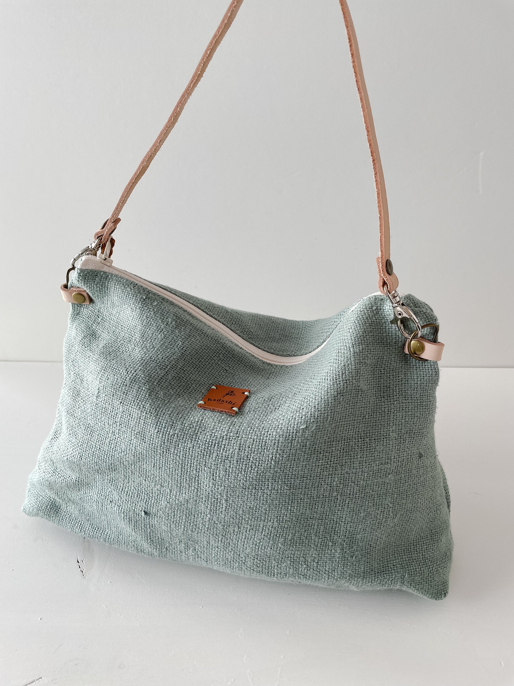 linen slouchy pouch in green with thin leather strap