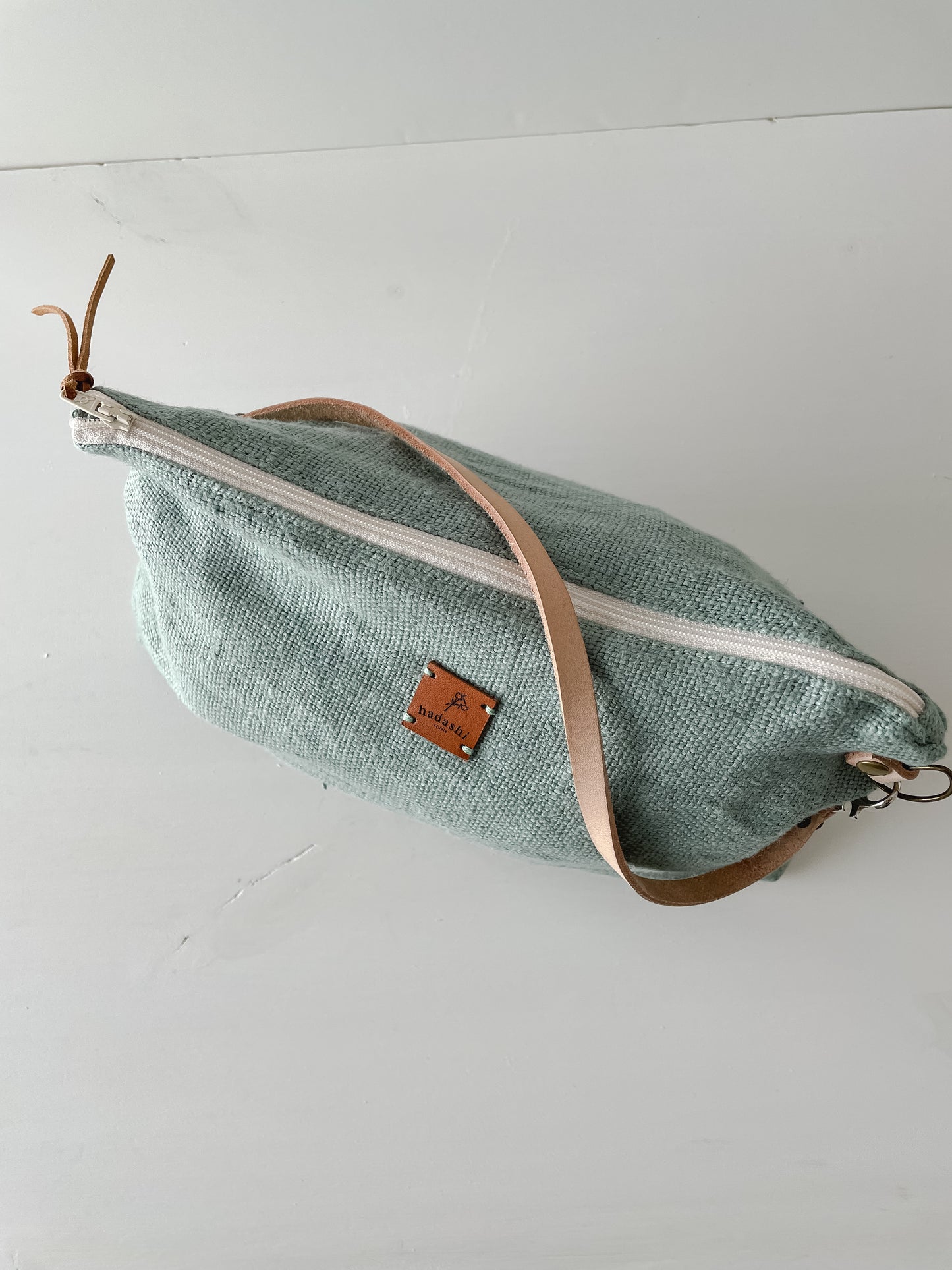 linen slouchy pouch in green with thin leather strap