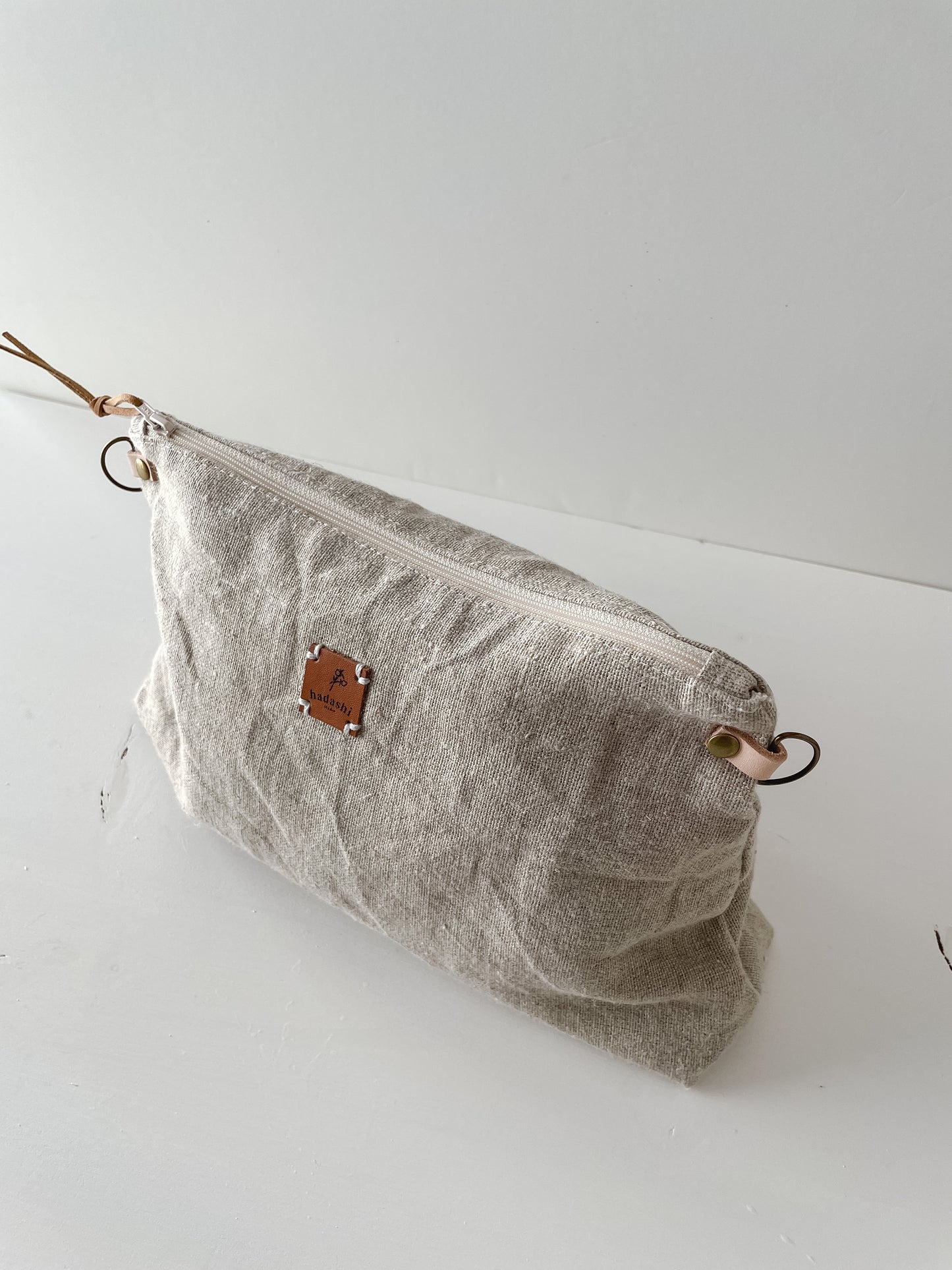 linen slouchy pouch in beige with thin leather strap