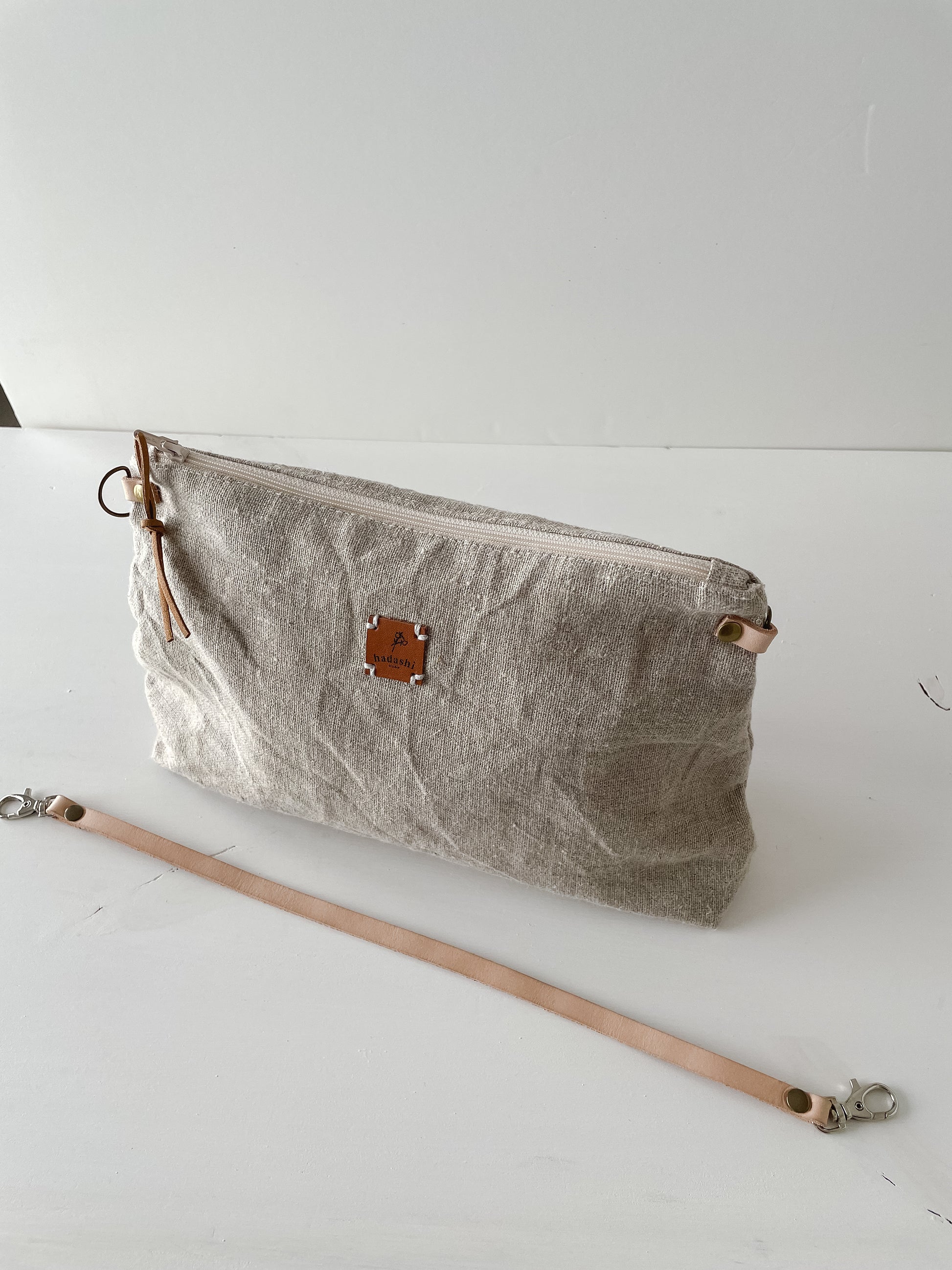 linen slouchy pouch in beige with thin leather strap