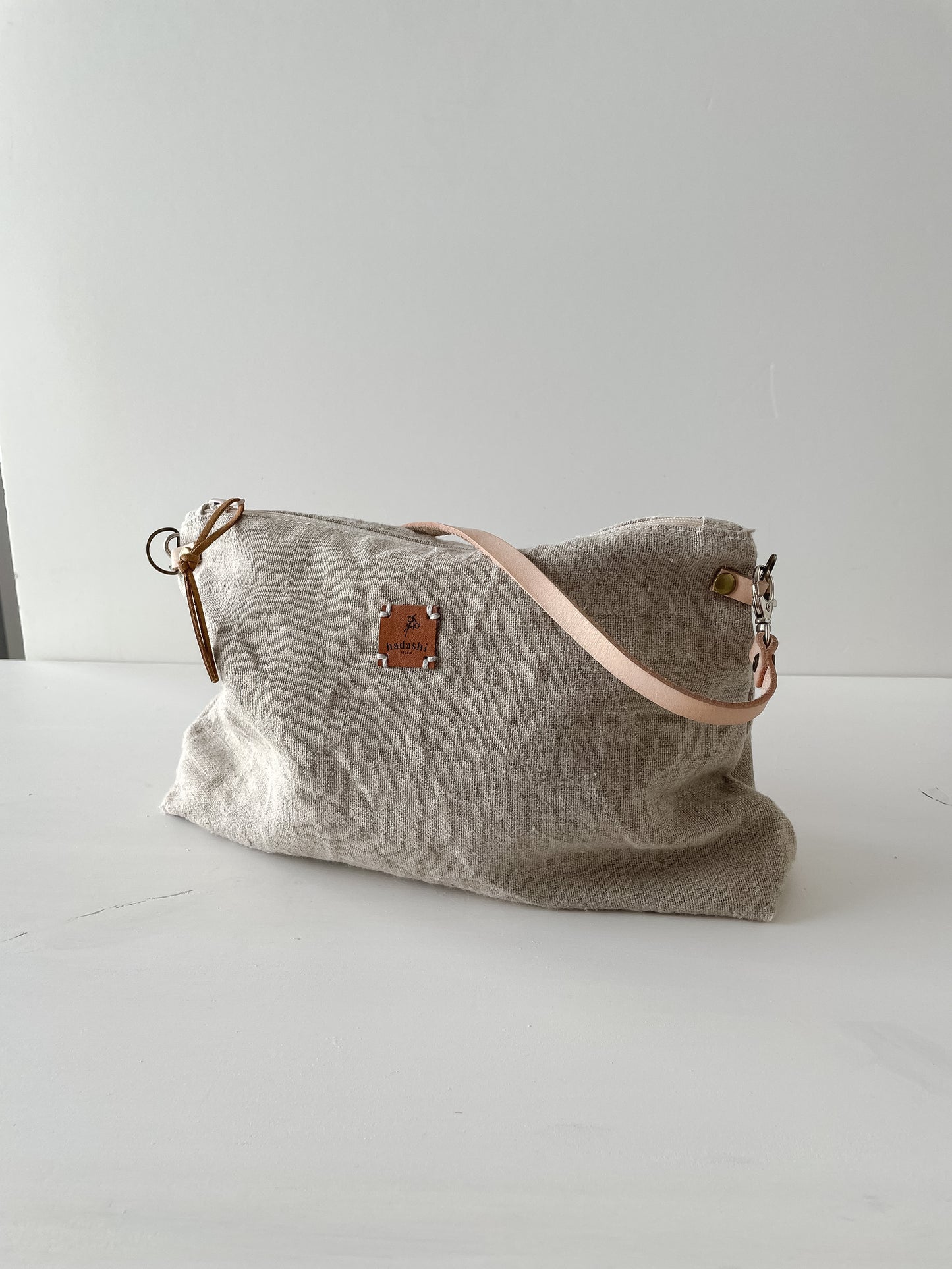 linen slouchy pouch in beige with thin leather strap