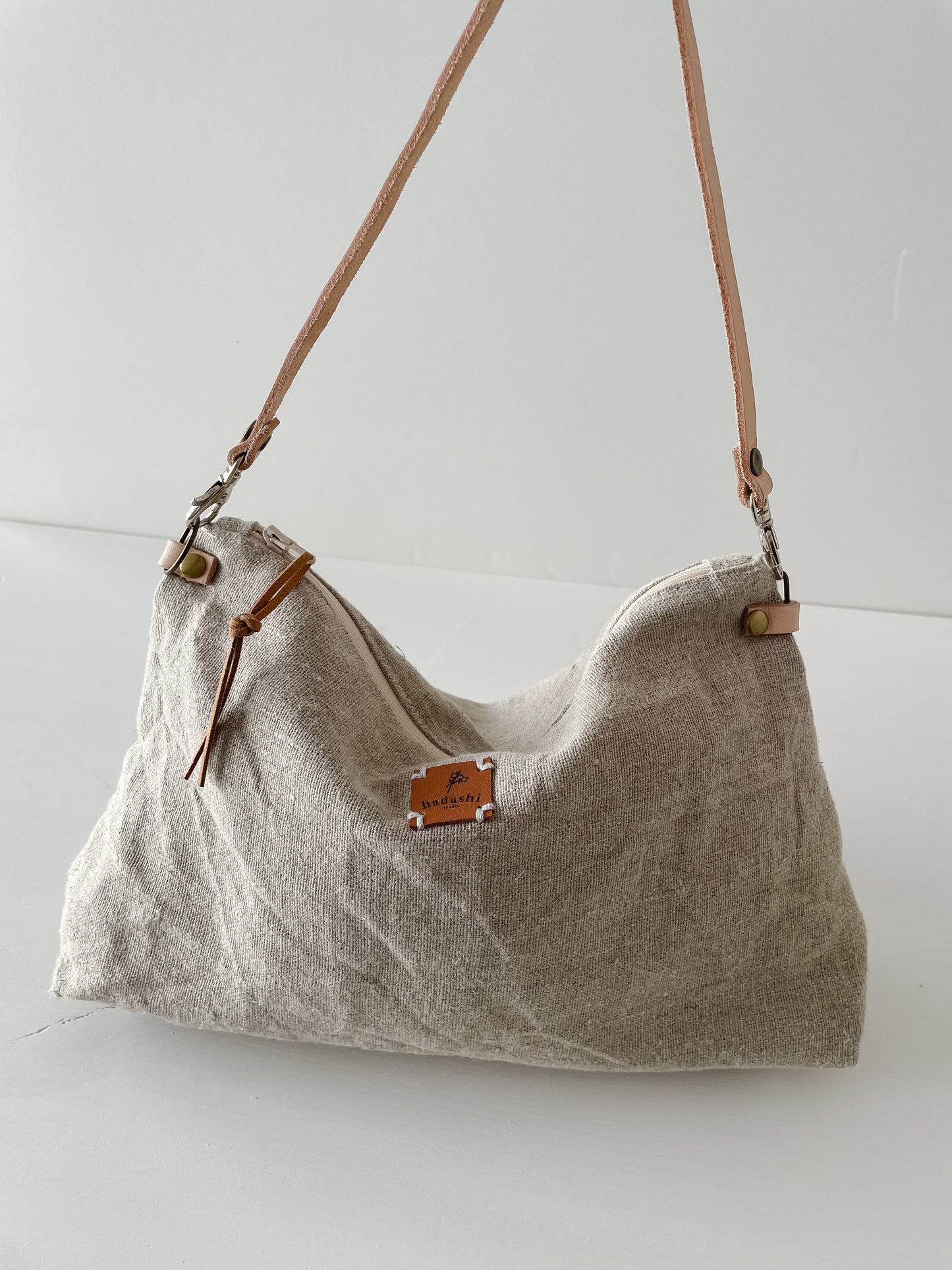 linen slouchy pouch in beige with thin leather strap