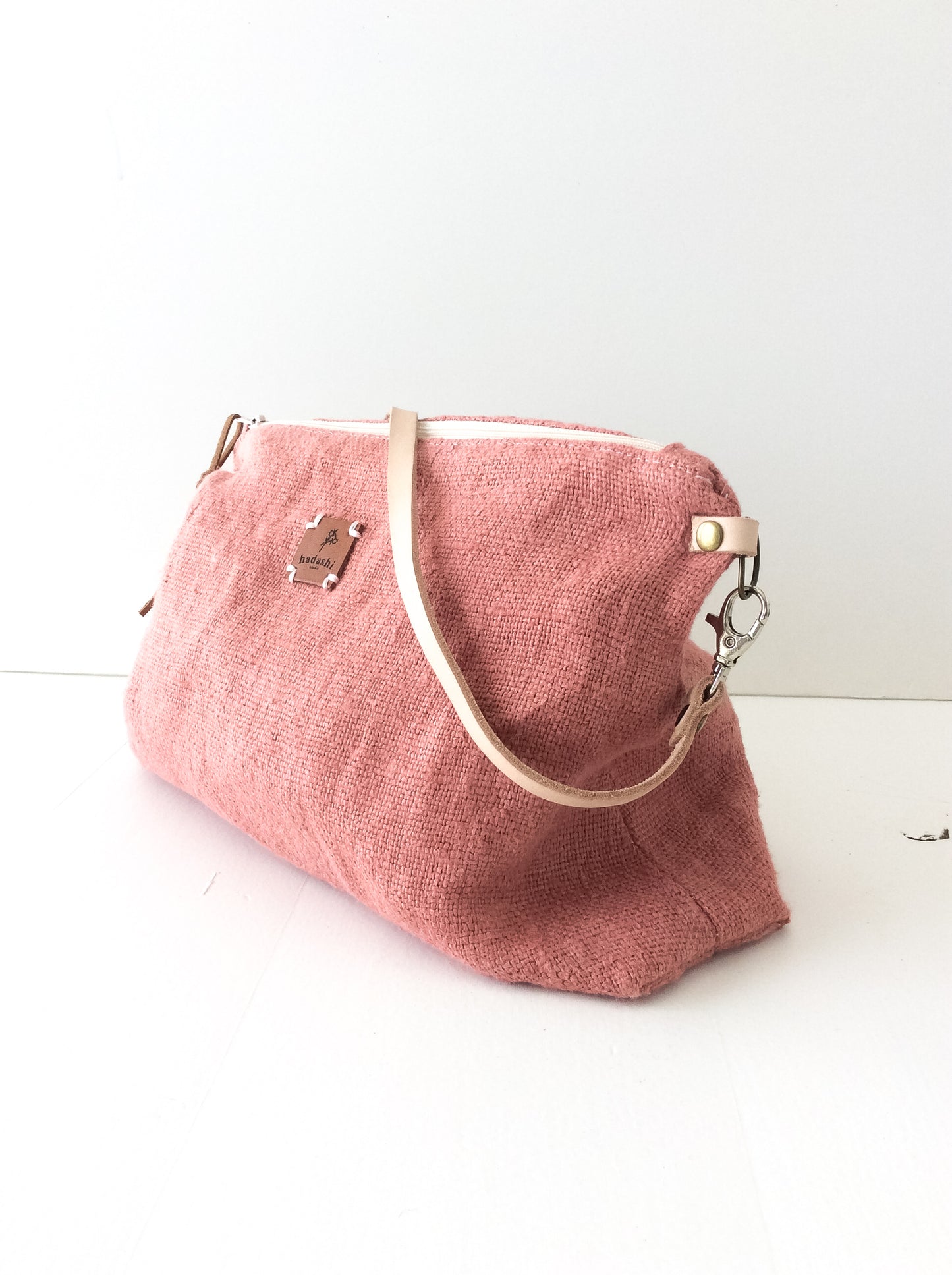 linen slouchy pouch in rose with a thin leather strap