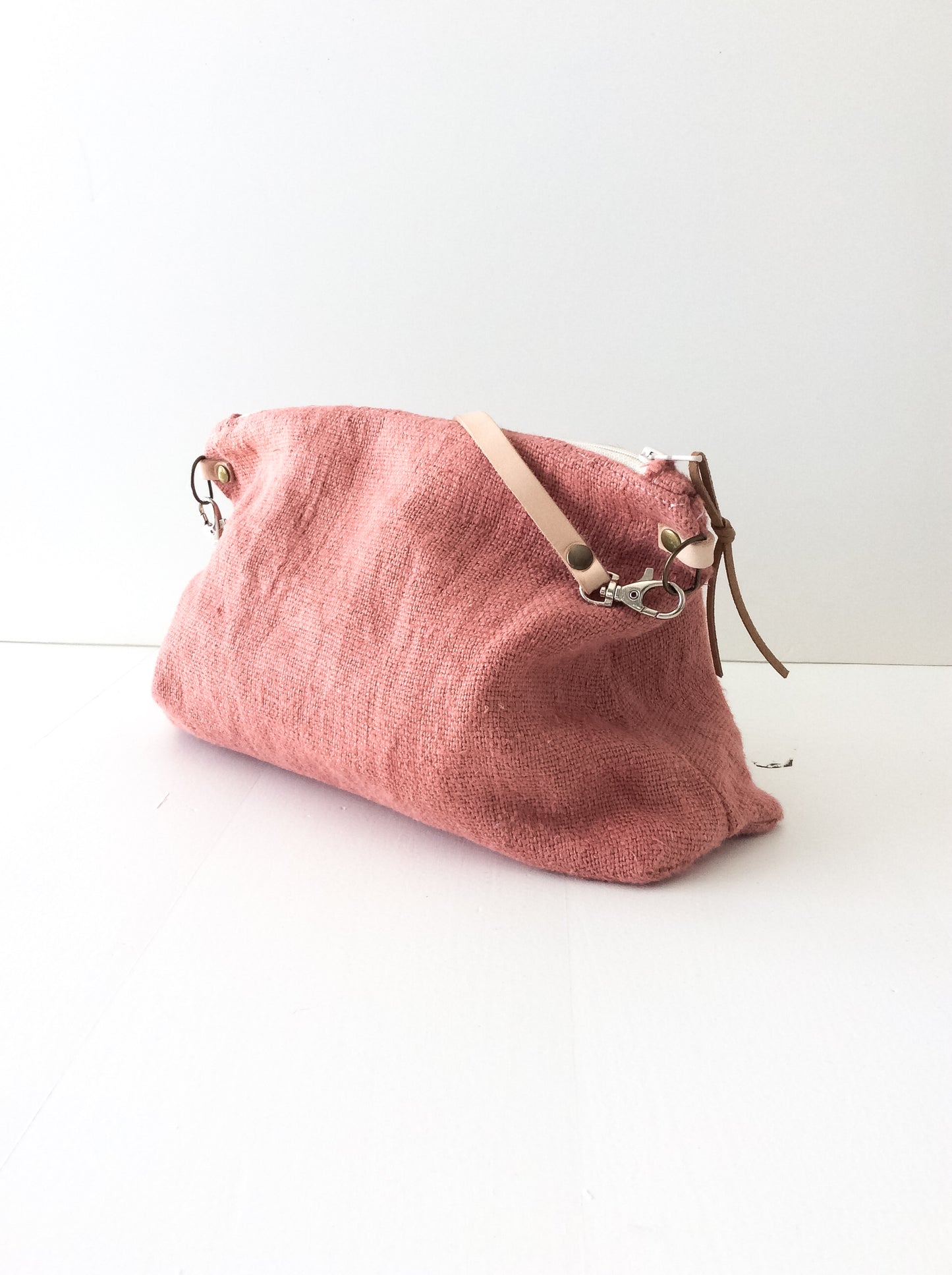 linen slouchy pouch in rose with a thin leather strap