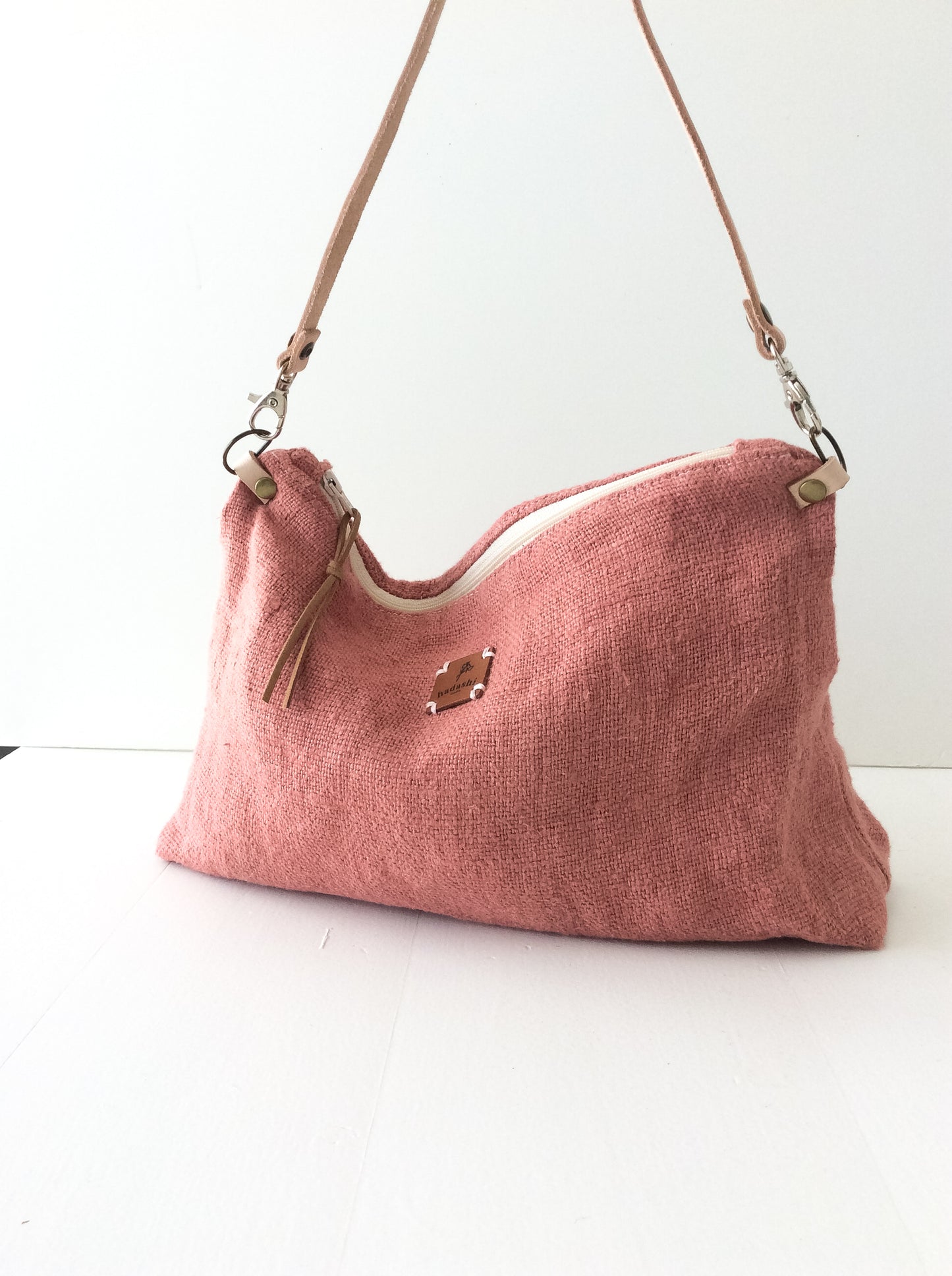 linen slouchy pouch in rose with a thin leather strap